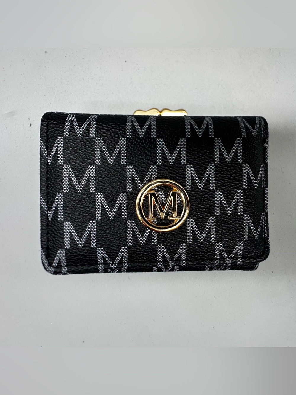 Trifold Woman’s wallet featuring an "M" monogram pattern